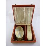 ALBERT CARTER A GENTLEMAN'S SILVER BRUSH SET having engine turned backs and monogrammed,