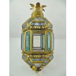 A MIDDLE EASTERN DESIGN HANGING LANTERN having decorative brass frame with tinted glass panels, 48cm