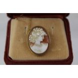 A 9CT GOLD AND SHELL CAMEO BROOCH carved with a female head and rope wire surround