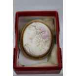 A VICTORIAN CLASSICAL FORM CAMEO BROOCH, depicting the profile head of a young woman with flowers in