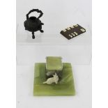 AN ART DECO ONYX INKWELL with painted cast metal terrier mount, 15cm wide, a cast metal and