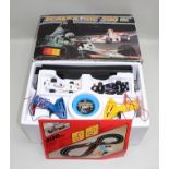A SCALEXTRIC 200 ELECTRIC MODEL RACING KIT complete with two cars, controllers and track,