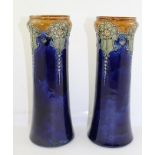 A PAIR OF ROYAL DOULTON STONEWARE VASES of waisted form, blue glazed with piped and applied floral