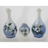 A PAIR OF ROYAL COPENHAGEN PORCELAIN VASES each of ovoid bulb form decorated with white flora,