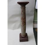 A 19TH CENTURY ROSSO ANTICO MARBLE DISPLAY COLUMN on stepped square base, with rotating top, 107cm