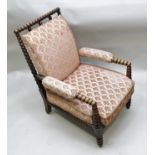 A 19TH CENTURY BOBBIN TURNED LIBRARY ARM CHAIR, upholstered and raised on tapering turned fore