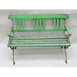 AN EDWARDIAN CHILD'S GARDEN BENCH, wrought iron and wooden lathe of open arm design, green