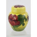 A MOORCROFT GINGER JAR AND COVER, yellow fading to green ground, with hibiscus pattern, with piped
