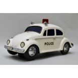 A JAPANESE BATTERY OPERATED VW BEETLE POLICE CAR in white livery, length 30cm