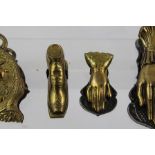 FOUR LATE VICTORIAN CAST BRASS LETTER CLIPS, one embossed with a portrait of Mercury (God of