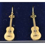 A PAIR OF 9CT. GOLD DROP EARRINGS each with a guitar drop and wire fitting
