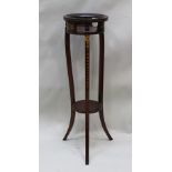 A CIRCULAR TOPPED JARDINIERE STAND in the Sheraton style, on three outswept legs united by a shell