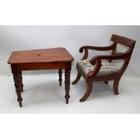 A MAHOGANY REGENCY DESIGN CHILD'S CHAIR of open arm form on sabre leg supports with upholstered seat