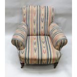 AN EDWARDIAN DEEP SEATED EASY CHAIR with turned polished wood fore supports in blue and red design