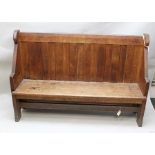 A 19TH CENTURY OAK LOW BACK SETTLE BENCH with shaped ends, 168cm wide