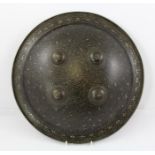 A 19TH CENTURY INDIAN DHAL SHIELD, of convex circular form with four raised bosses, overall stylised