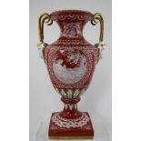 A CONTINENTAL PORCELAIN VASE OF URN FORM terracotta glazed ground with pate sur pate style classical