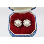 A PAIR OF 18ct WHITE GOLD, PEARL AND DIAMOND CLUSTER EARRINGS, each having a single cultured pearl