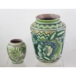 A 1960'S POOLE EARTHENWARE VASE boldly decorated in a green stylised floral palette, 26cm high and