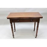 A VICTORIAN MAHOGANY FOLDOVER TEA TABLE fitted faux frieze drawer, raised on ring turned supports