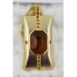 A 1970's BUTLER & WILSON BROOCH/PENDANT in amber glass