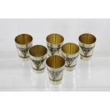 A SET OF SIX RUSSIAN NIELLO SILVER TOTS with gilded interiors and stylised floral decoration, 171g