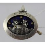 AN OVAL SILVER AND BLUE ENAMEL BROOCH 'Rocking the Boat' with two animals in