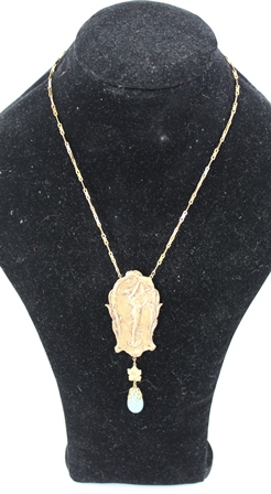AN ART NOUVEAU PERIOD GILT METAL PENDANT with female plaque and turquoise coloured dropper