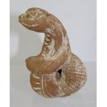 A TERRACOTTA MERETSEGER in the form of a sacred serpent, of coiled design, considered to be from the