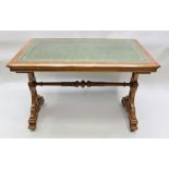 A 19TH CENTURY GOLDEN OAK GOTHIC REVIVAL WRITING TABLE having gilt tooled green leather surface,