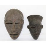 TWO CARVED WOOD AFRICAN MASKS, with scarification decoration, largest 28cm high