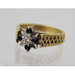 A 1970'S/80'S GOLD COLOURED METAL SAPPHIRE AND DIAMOND DRESS RING, having single illusion set