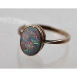 AN OPAL DOUBLET SINGLE STONE DRESS RING, in gold coloured metal setting, stamped 9ct., size N 1/2