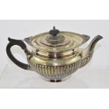 A WALKER & HALL EDWARDIAN SILVER TEAPOT, of fluted Georgian design with ebonised handle and hinged