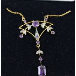 AN ART NOUVEAU STYLE DIAMOND AND AMETHYST MOUNTED GOLD COLOURED METAL PENDANT, with leaf motifs,