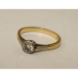 A DIAMOND SOLITAIRE, having single brilliant in illusion gold coloured metal setting, stamped