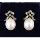 A PAIR OF DIAMOND AND PEARL EARRINGS, each having a bow set with small diamonds and large single