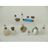 A SELECTION OF SILVER MOUNTED VANITY BOTTLES, including a double ended blue scent, paste jars, etc.,