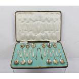 DUNCAN & SCOBBIE A SET OF TWELVE EARLY 20TH CENTURY SILVER TEASPOONS AND SUGAR NIPS with bound