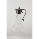 A CLARET JUG, the plated cover with mask spout and integral handle, moulded glass flared body,