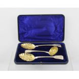 A MATCHED SILVER DESSERT SERVING SET, comprising of two berry spoons and a sugar sifting ladle,