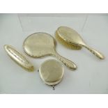 A SELECTION OF DIS-SIMILAR SILVER DRESSING TABLE ITEMS comprising; a hand mirror, clothes and hair