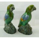 TWO 20TH CENTURY MINTONS POLYCHROME EARTHENWARE MODELS OF PARROTS, each moulded on a naturalistic