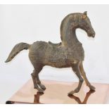 A CAST METAL TANG STYLE HORSE with blanket, bridle and saddle, 46cm nose to tail, standing on an