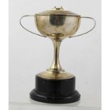 WALKER & HALL A TWO-HANDLED SILVER TROPHY CUP, on slender stem and platform foot, the cover with
