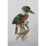 A GOEBEL MODEL OF THE EUROPEAN KINGFISHER, perched on a willow branch, decorated in polychrome,