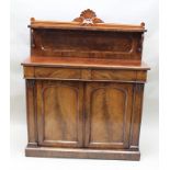 A REGENCY MAHOGANY CHIFFONIER having shelf and gallery back with carved shell motif, fitted two