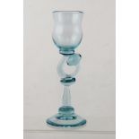 KARLIN RUSHBROOKE A PALE BLUE STUDIO GLASS with fancy shaped stem, on plain conical foot, 24cm high