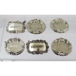 A SELECTION OF SIX ENGRAVED AND PRESSED PLATED DECANTER LABELS, "Whisky", "Whiskey", "Cognac", "