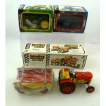 TWO TIN-PLATE CLOCKWORK TRACTORS, one with trailer, in original boxes, together with a BOXED "JOHN